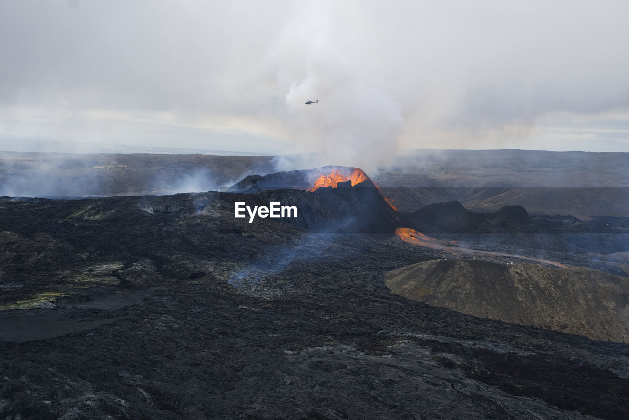 Smoke and lava emitting from volcanic mountain