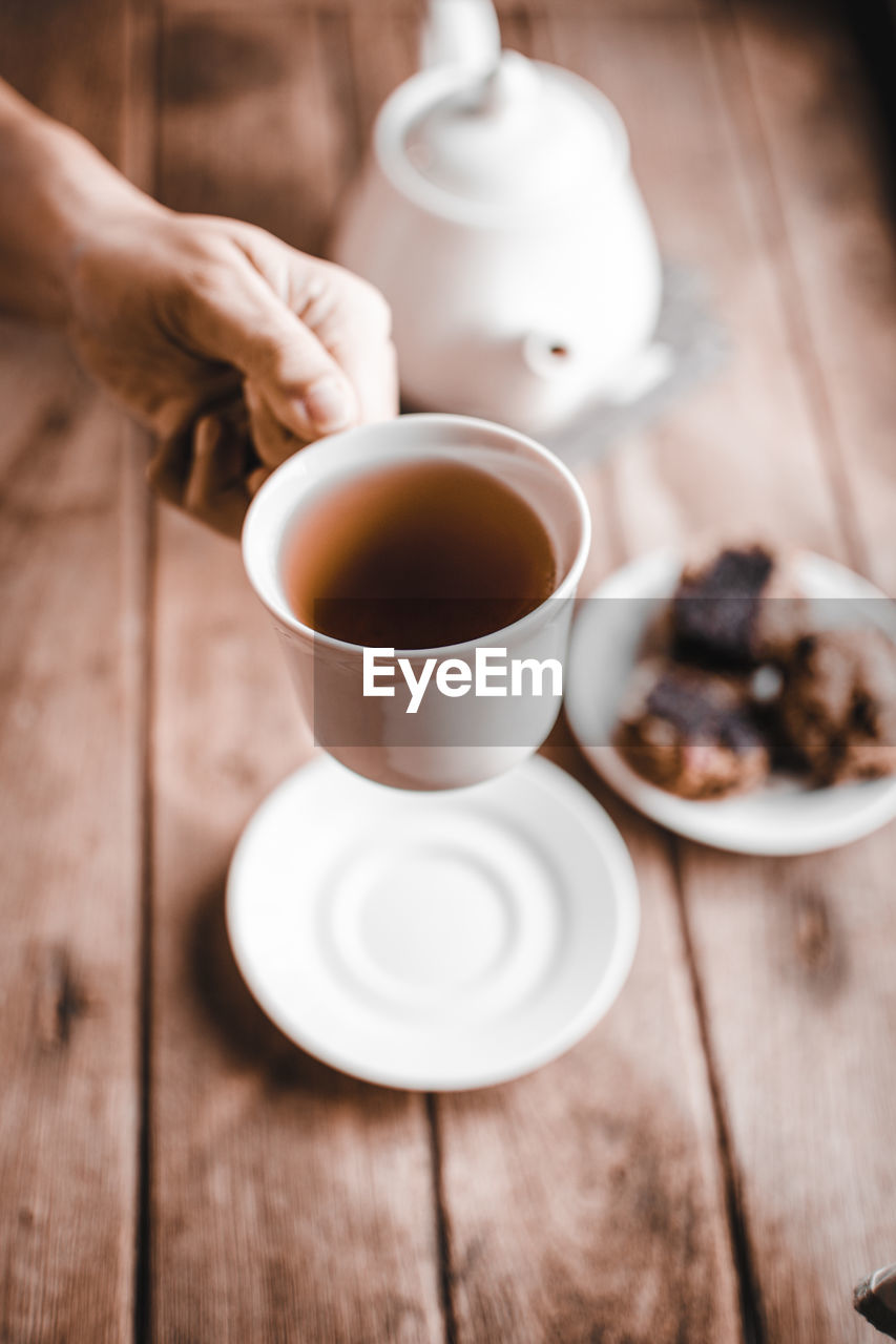 Midsection of tea cup on table