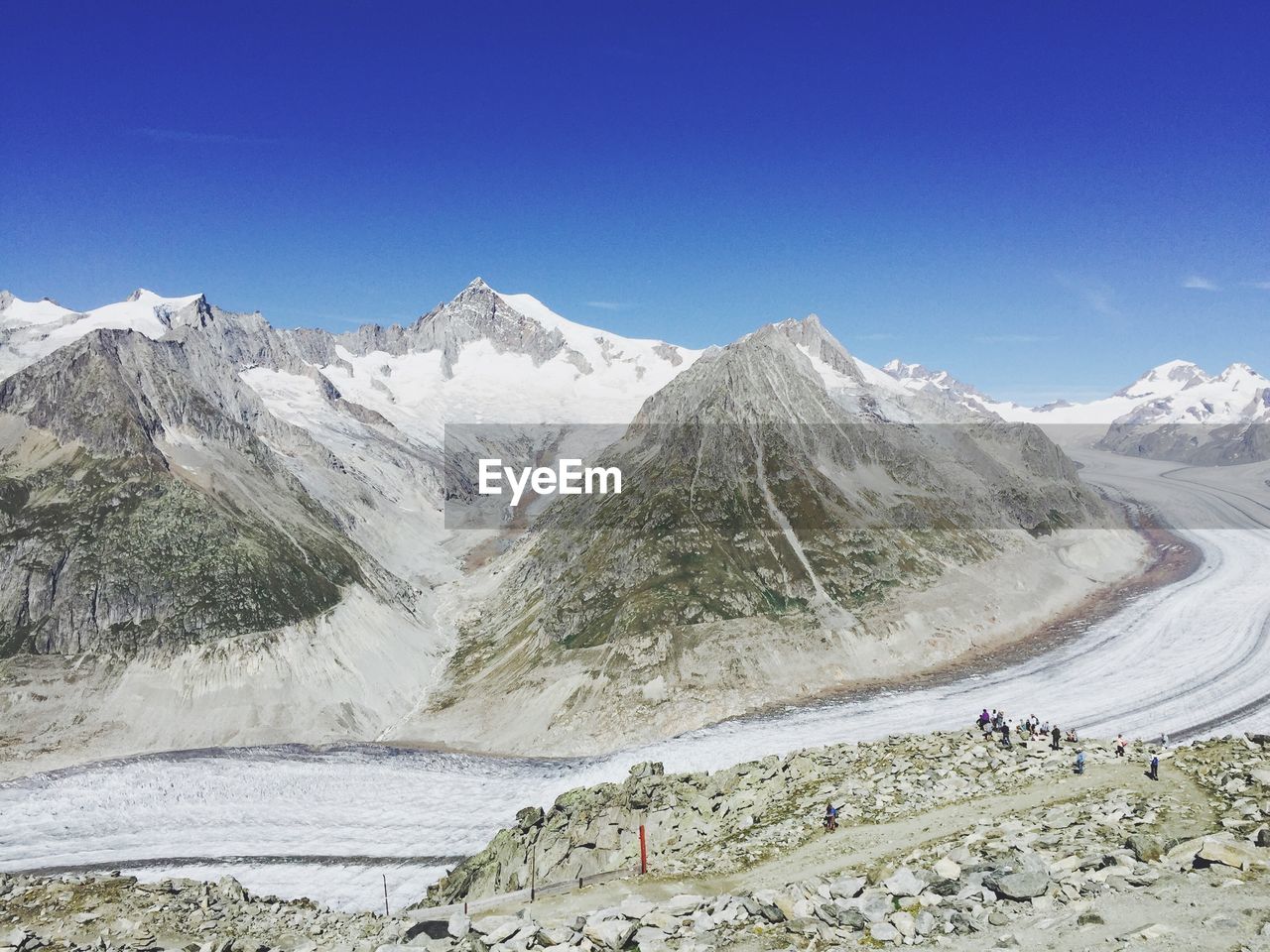 Scenic view of snow covered mountains against clear sky