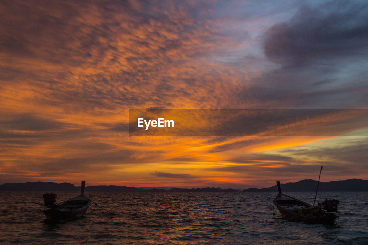 SILHOUETTE BOAT IN SEA AGAINST ORANGE SKY