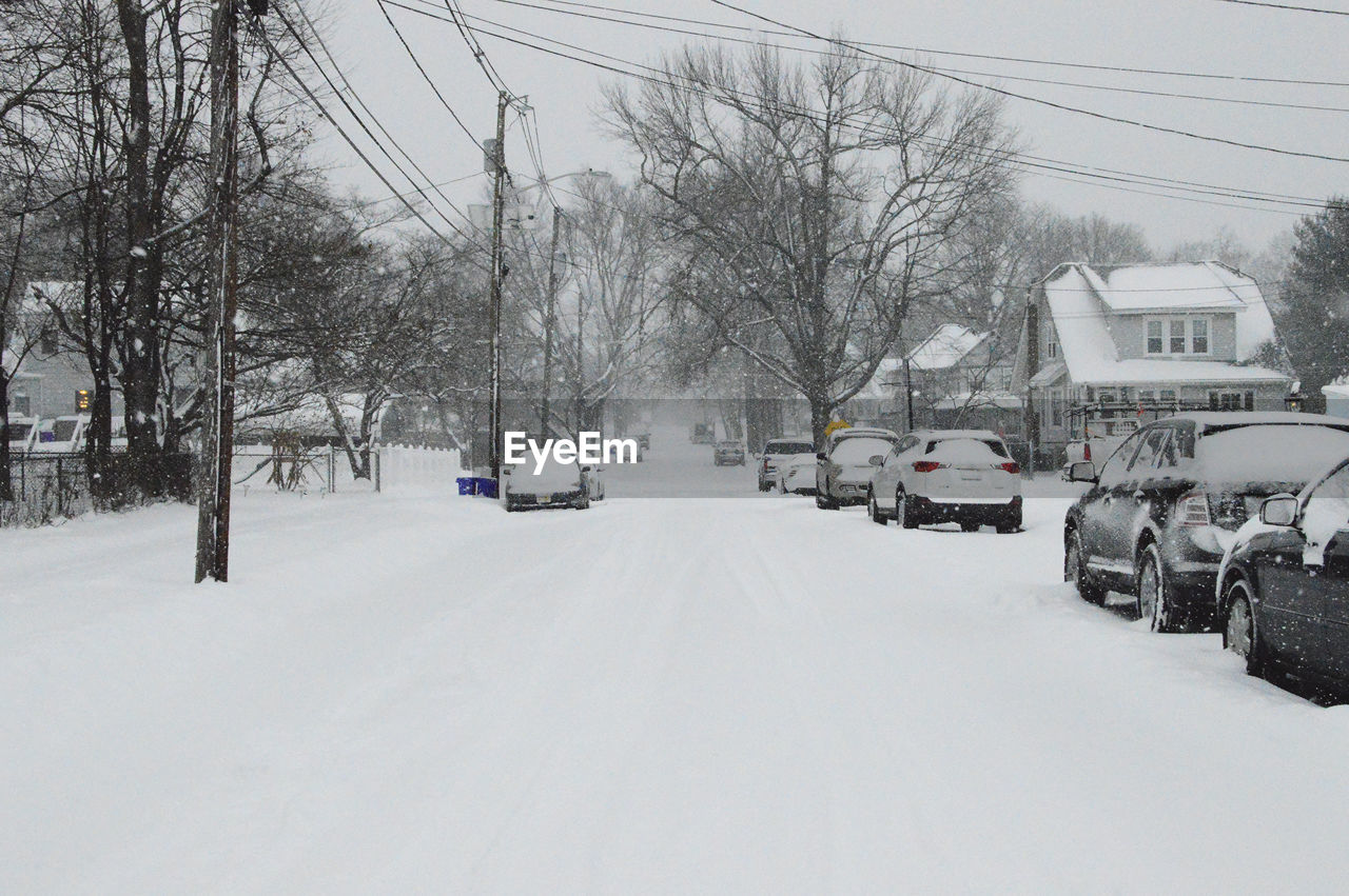 Cars parked by snow covered road