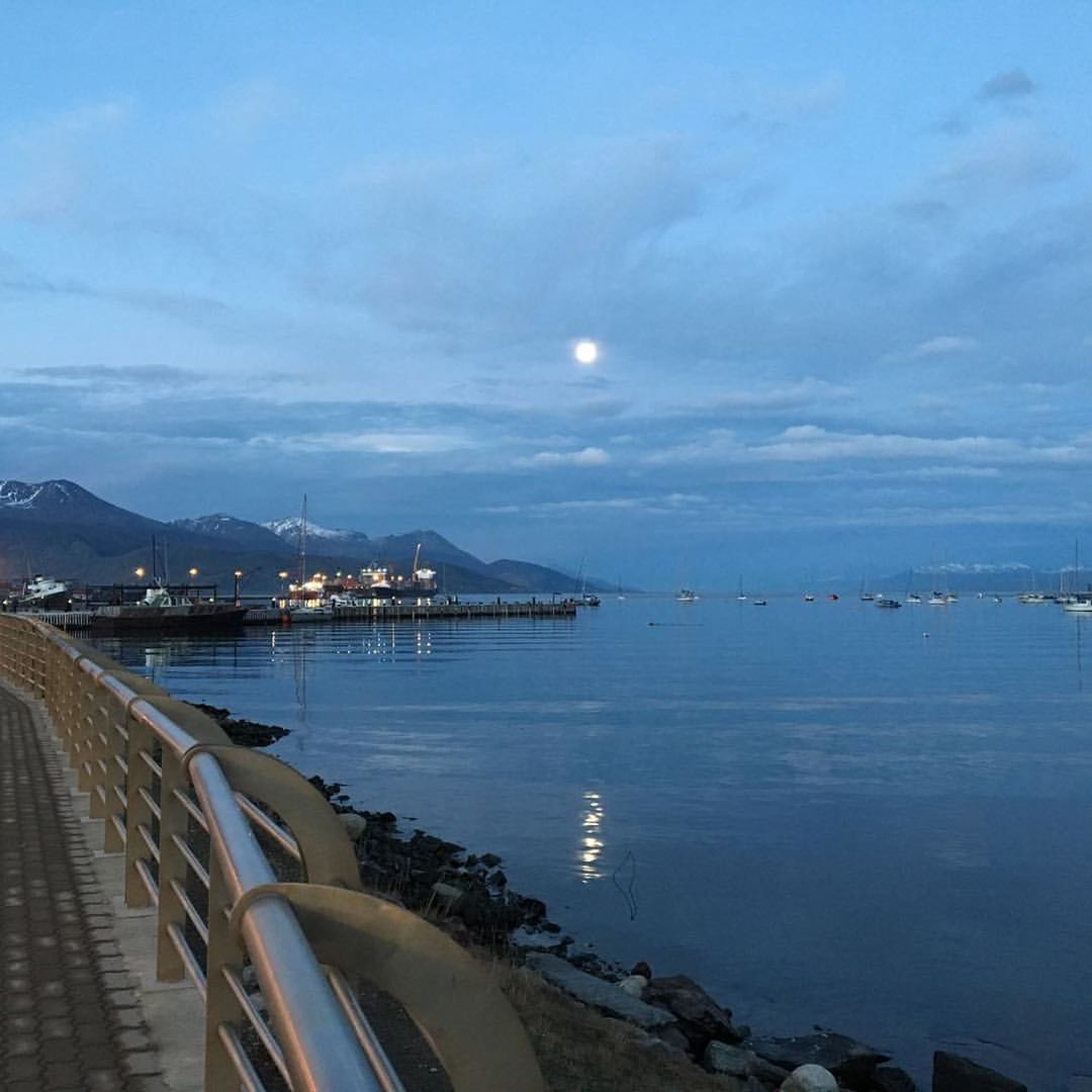 SCENIC VIEW OF SEA WITH MOUNTAIN IN BACKGROUND