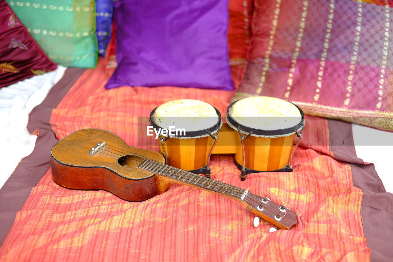 High angle view of musical instrument on bed