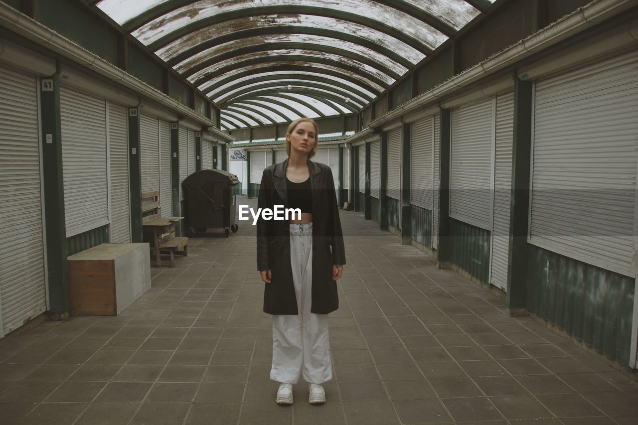 Full length of woman standing on tiled floor