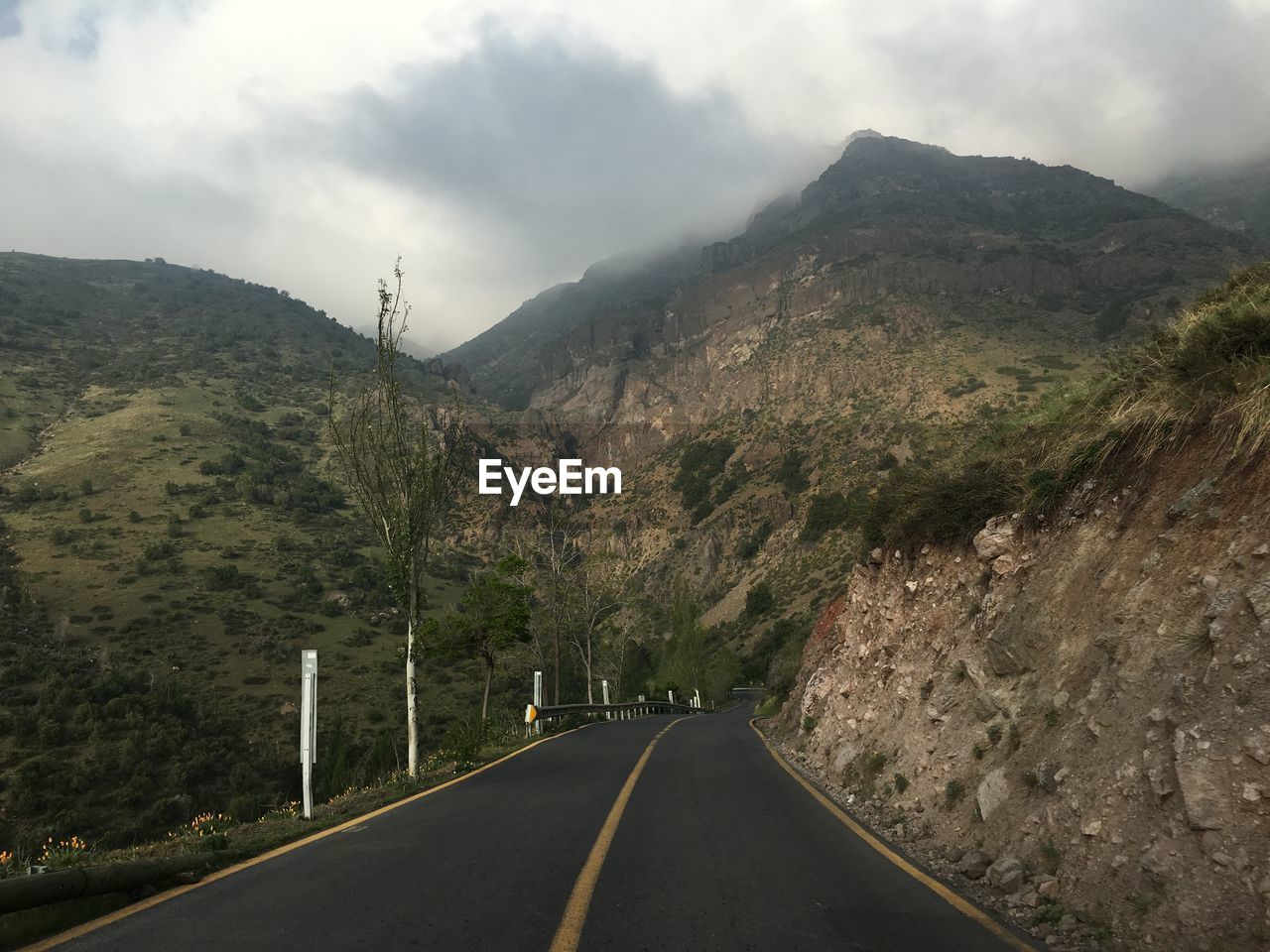 Empty road against mountains