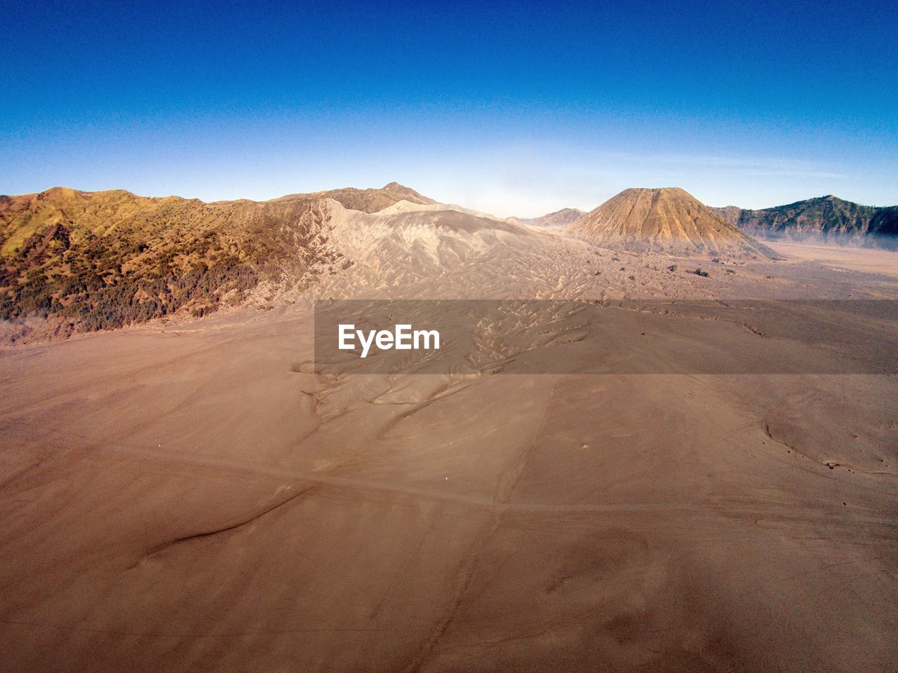 Scenic view of desert against blue sky