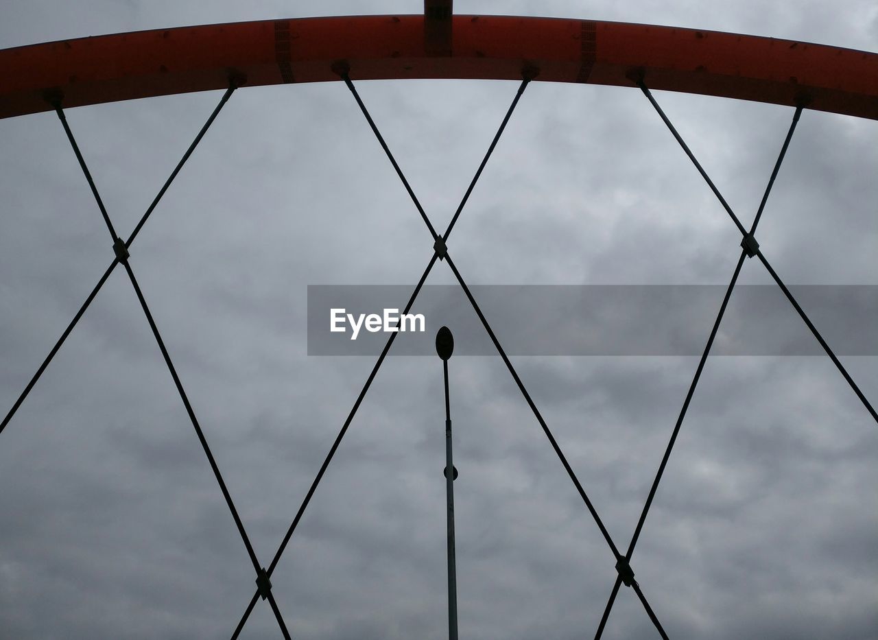 LOW ANGLE VIEW OF SKY SEEN THROUGH METAL FENCE