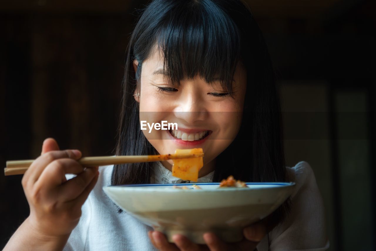 Smiling woman having food