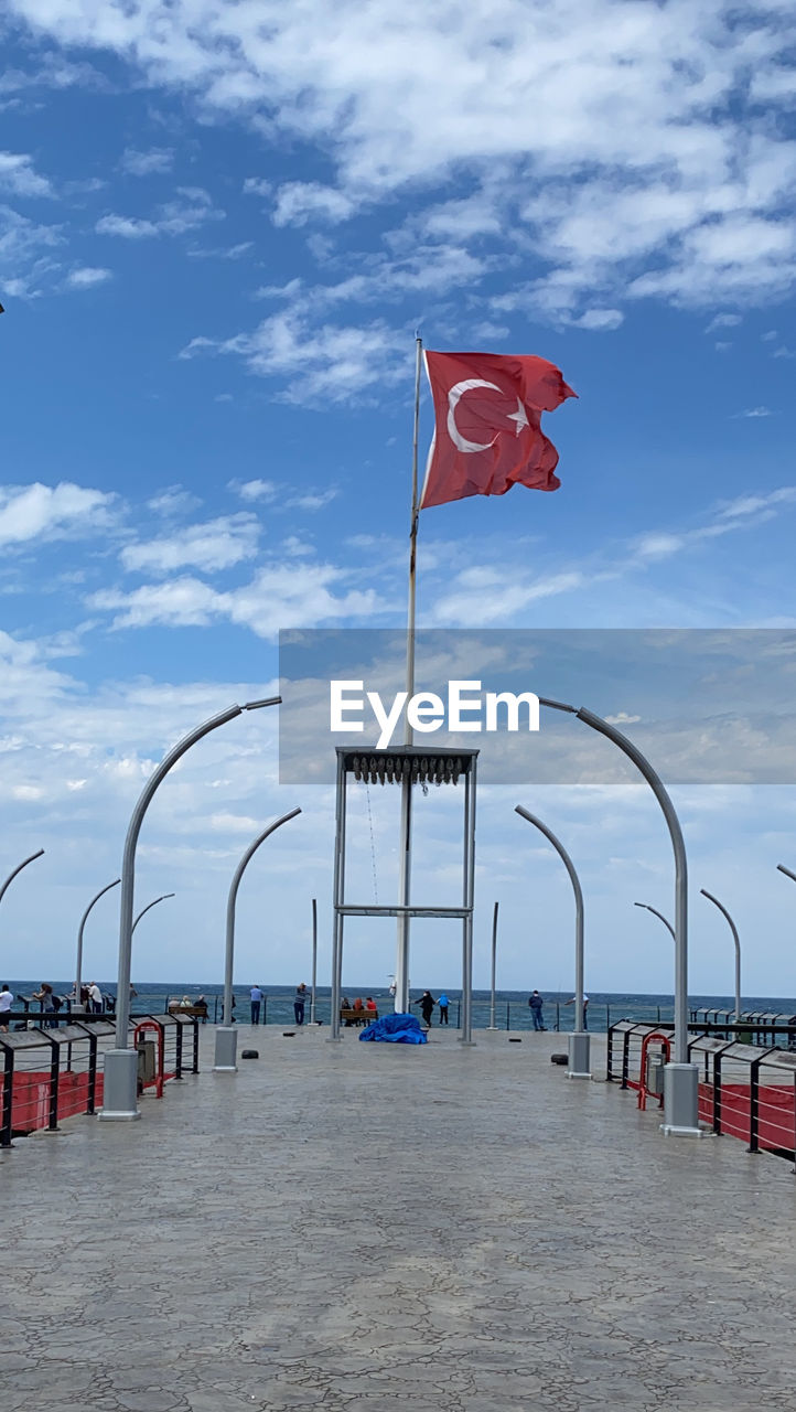 Flag on beach against sky