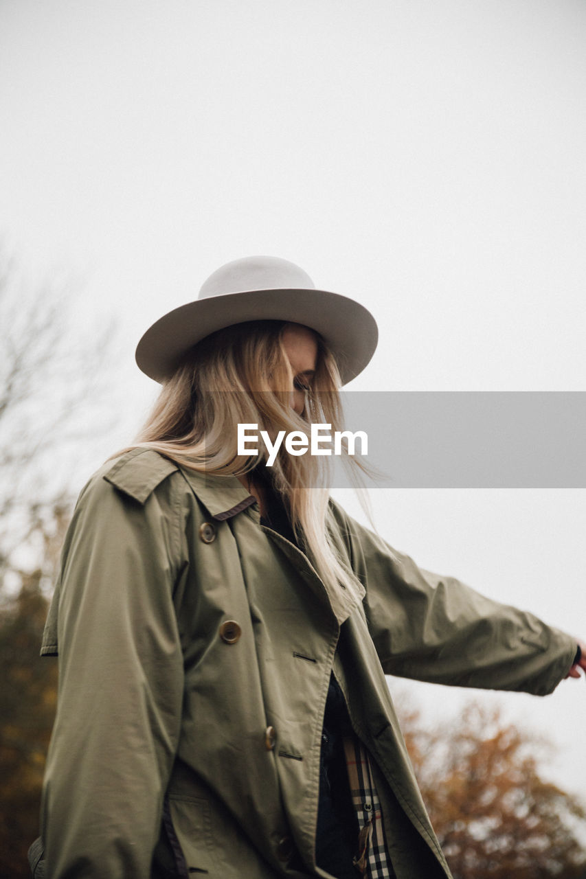 Woman wearing hat while standing outdoors