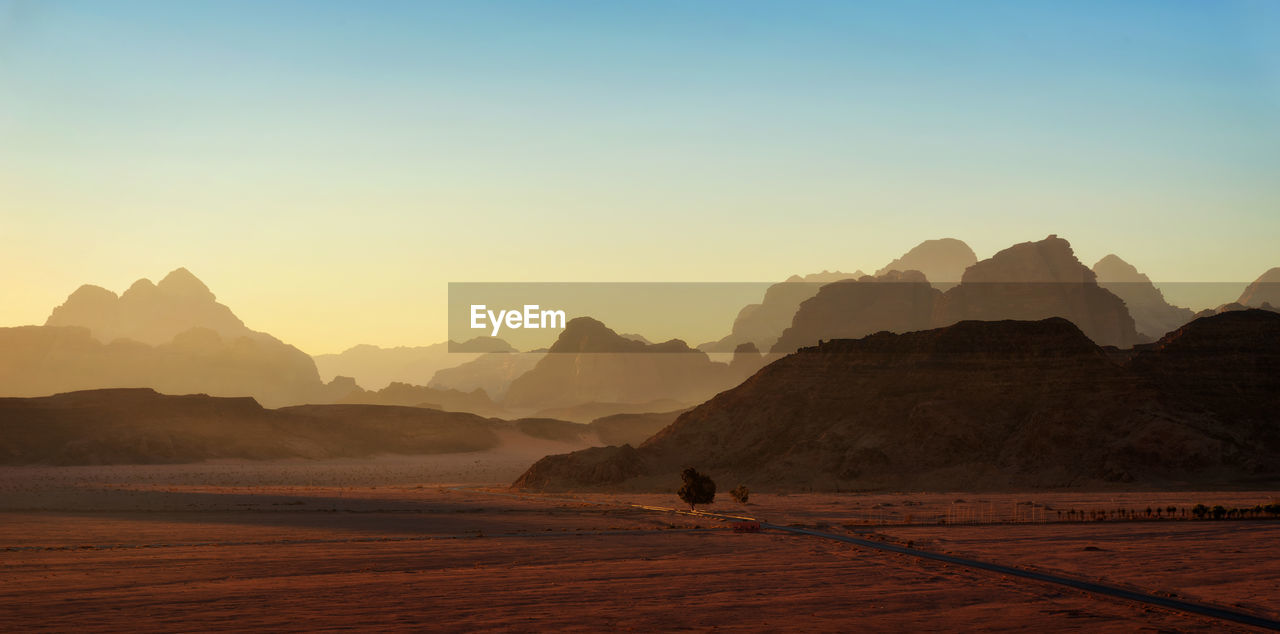 Scenic view of desert against sky during sunset