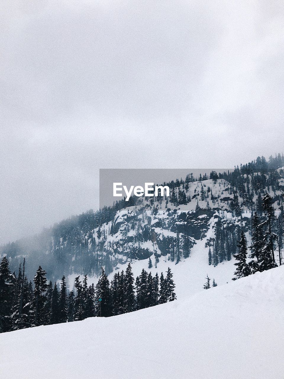 Scenic view of snow covered mountains against sky