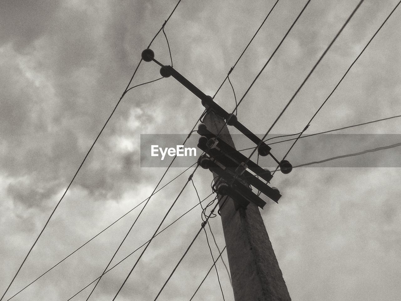 Low angle view of electricity pylon against sky