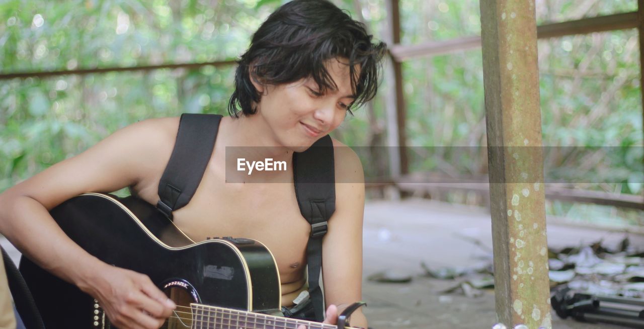 Young woman playing guitar