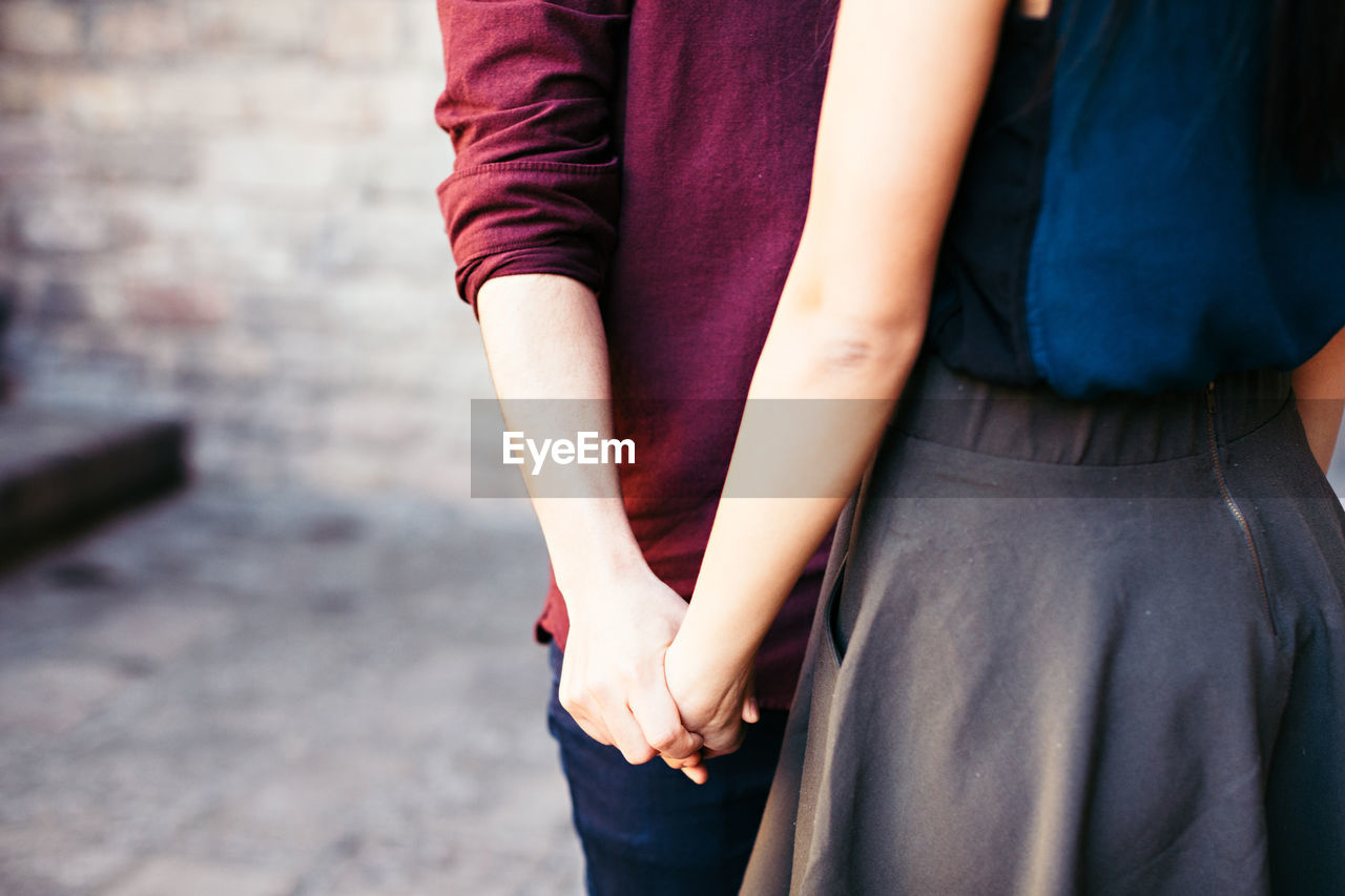 Close-up of couple holding hands