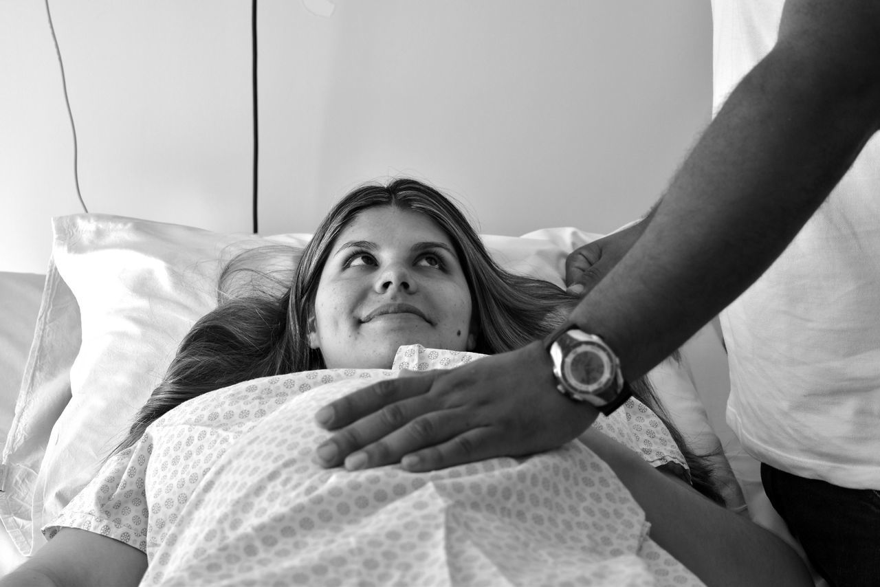 CLOSE-UP OF MAN AND WOMAN ON BED IN BEDROOM