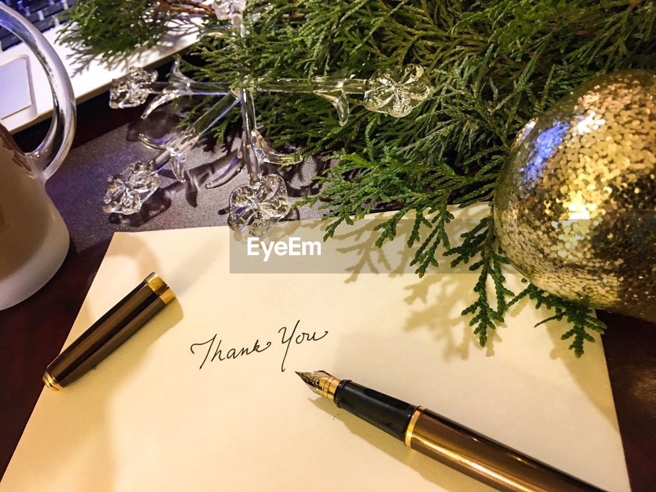 High angle view of pen with envelope by christmas decoration on table