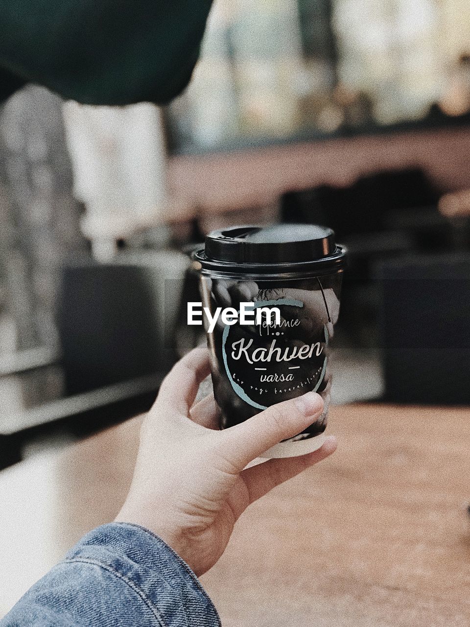 MIDSECTION OF MAN HOLDING COFFEE CUP WITH TEXT