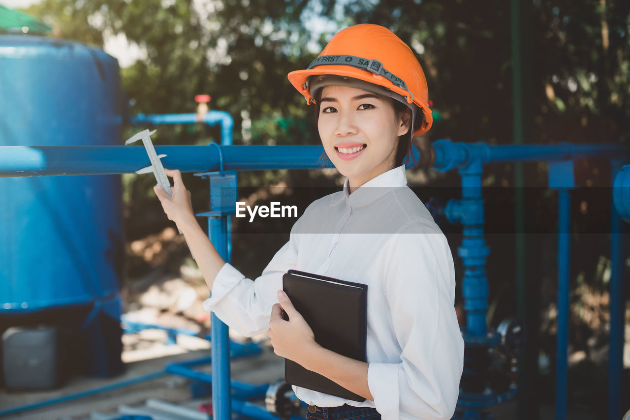 Portrait of smiling engineer working at industry