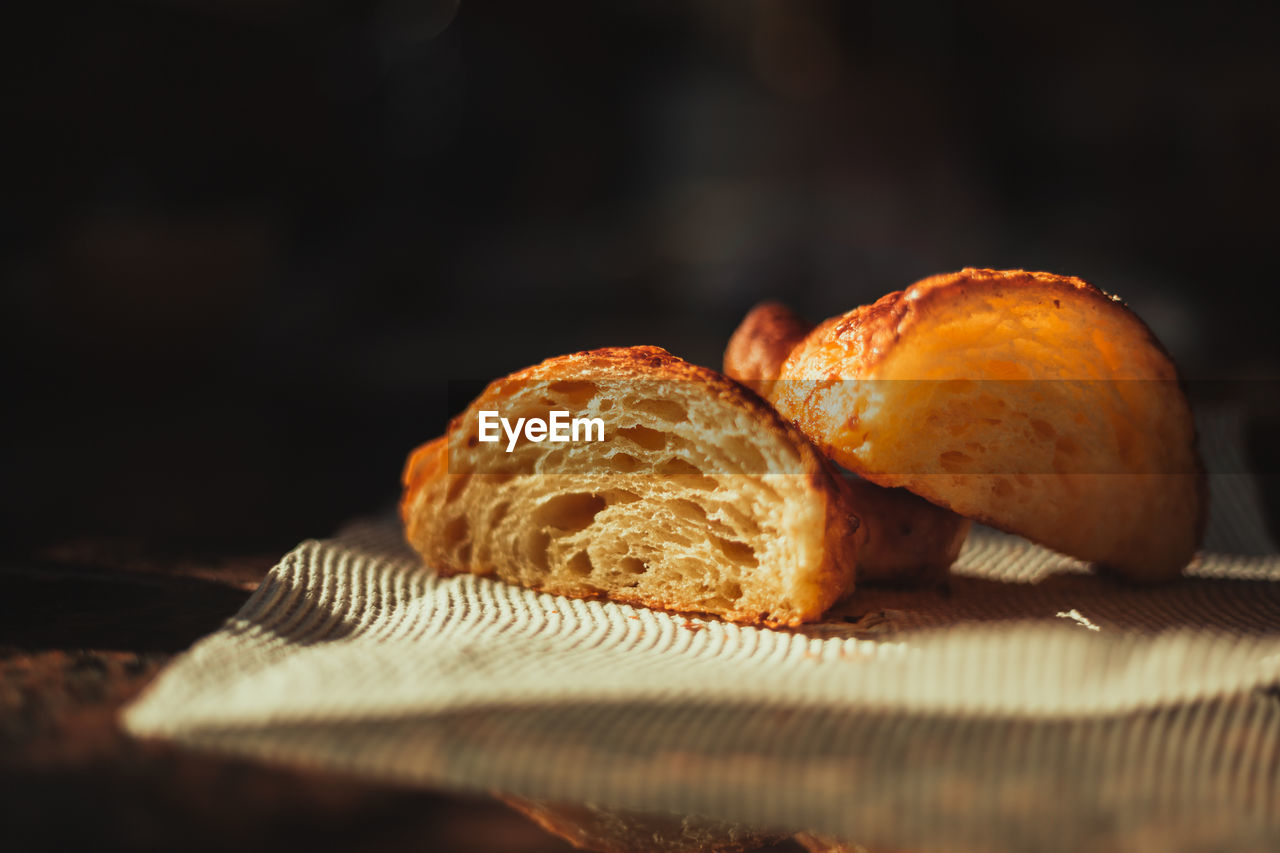 Close-up of croissant cut in half on table