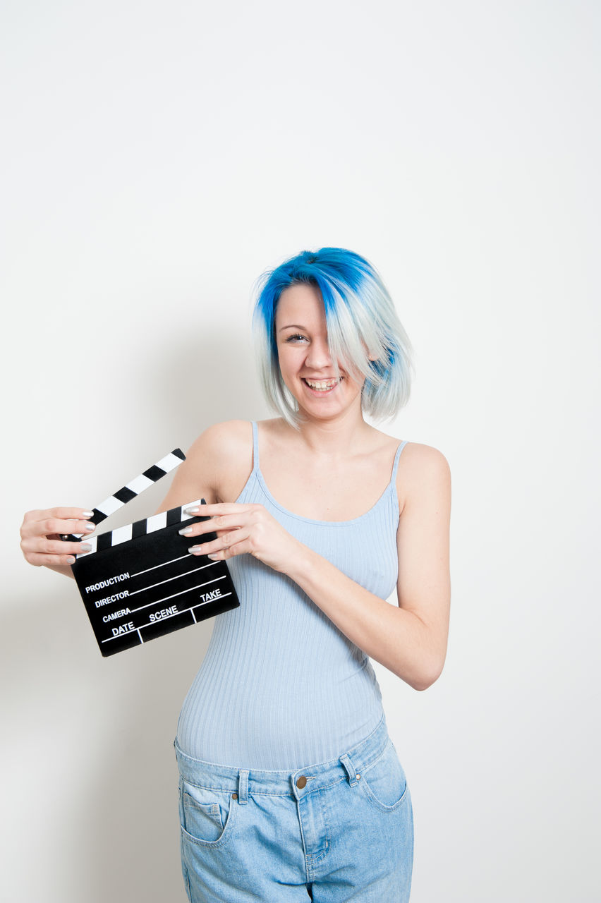 Portrait of a smiling young woman over white background