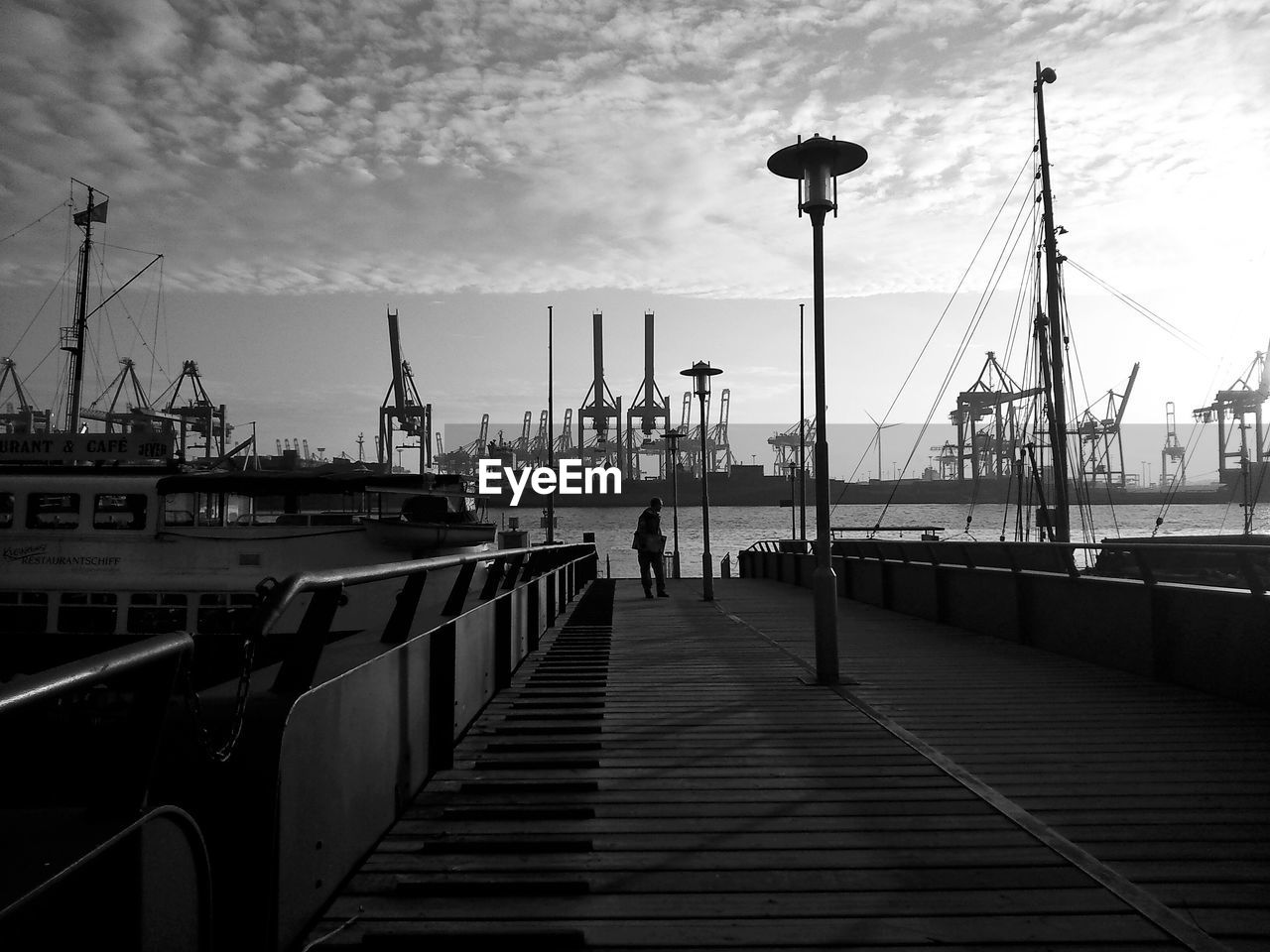 Man walking on pier at dock