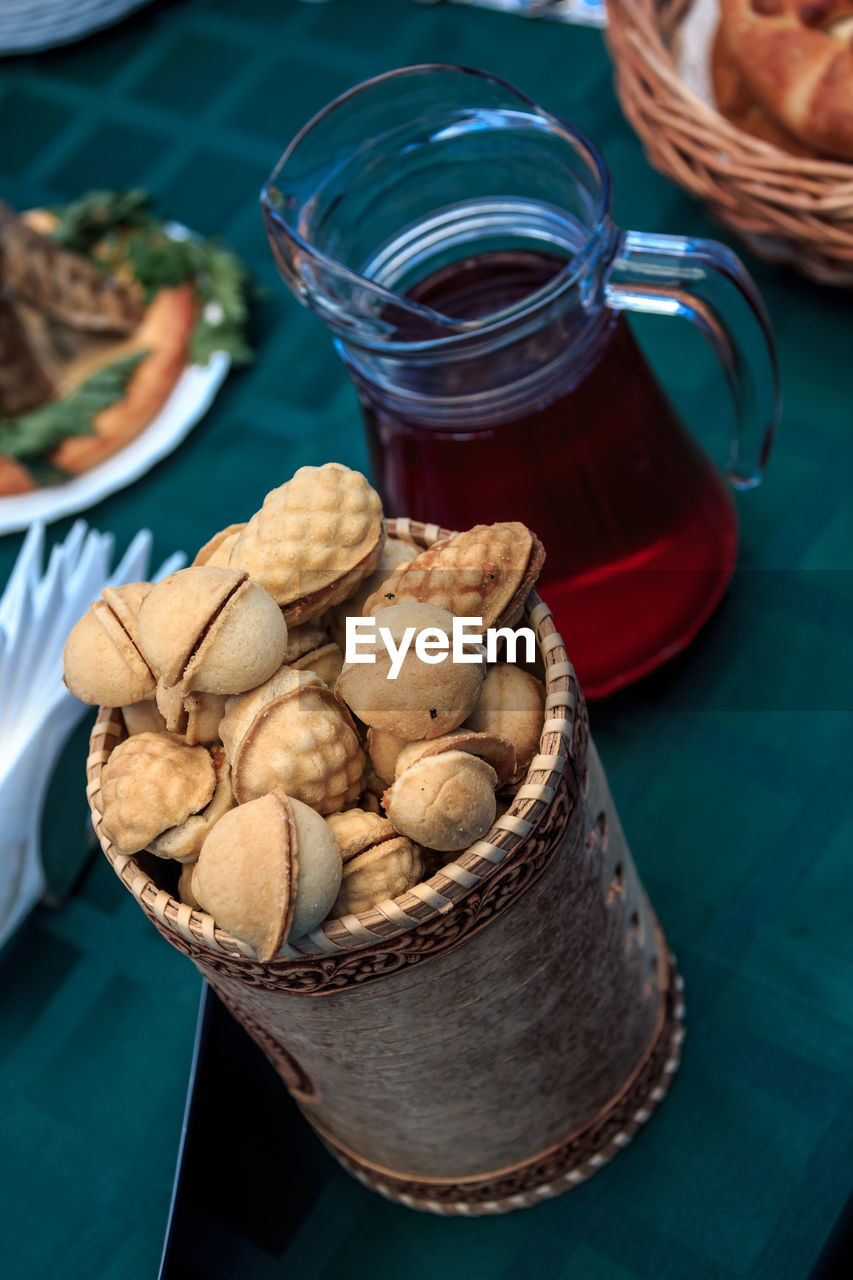 High angle view of cookies and compote in glass on table