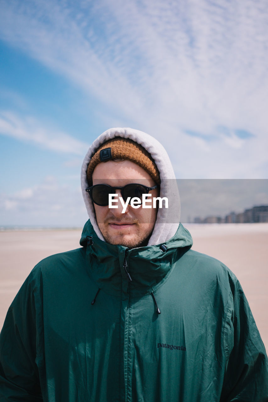 PORTRAIT OF HANDSOME MAN AGAINST SKY