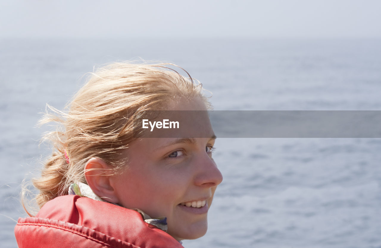 Close-up of smiling woman looking away