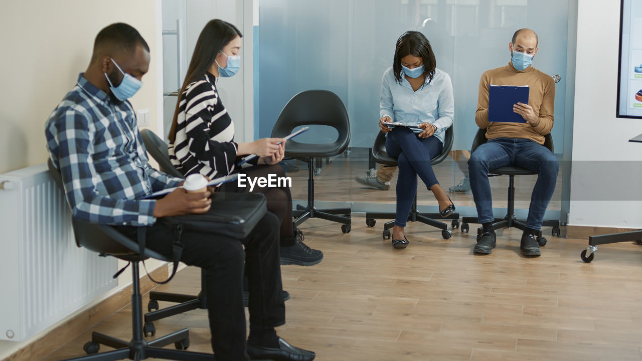 Candidates sitting with forms in office