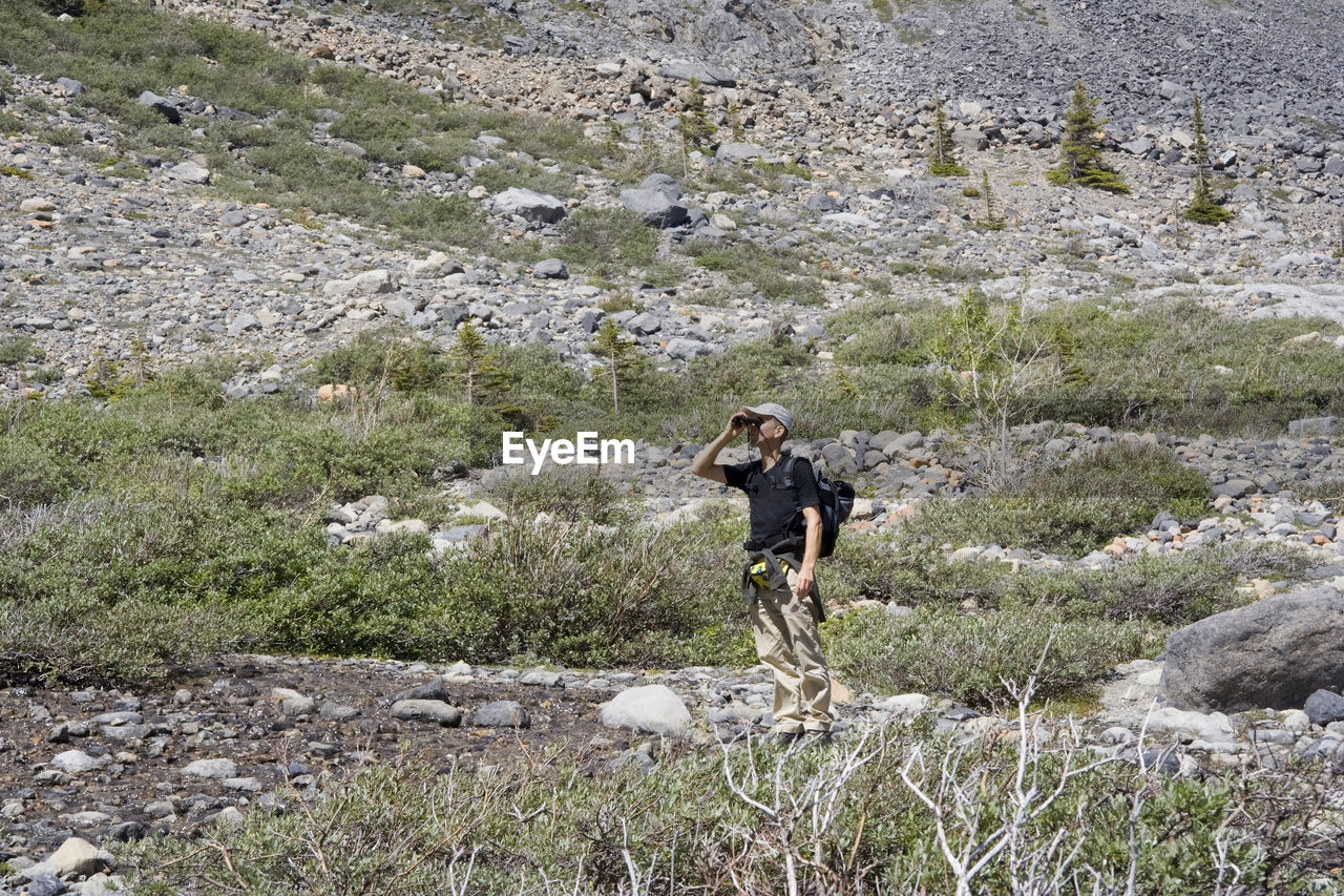 Full length of man standing on mountain