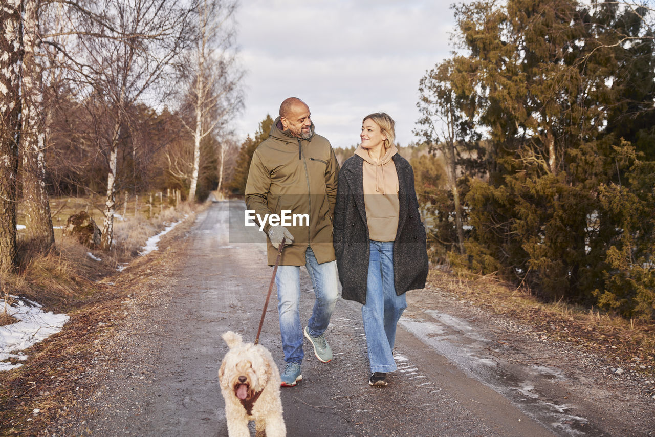 Couple walking with dog