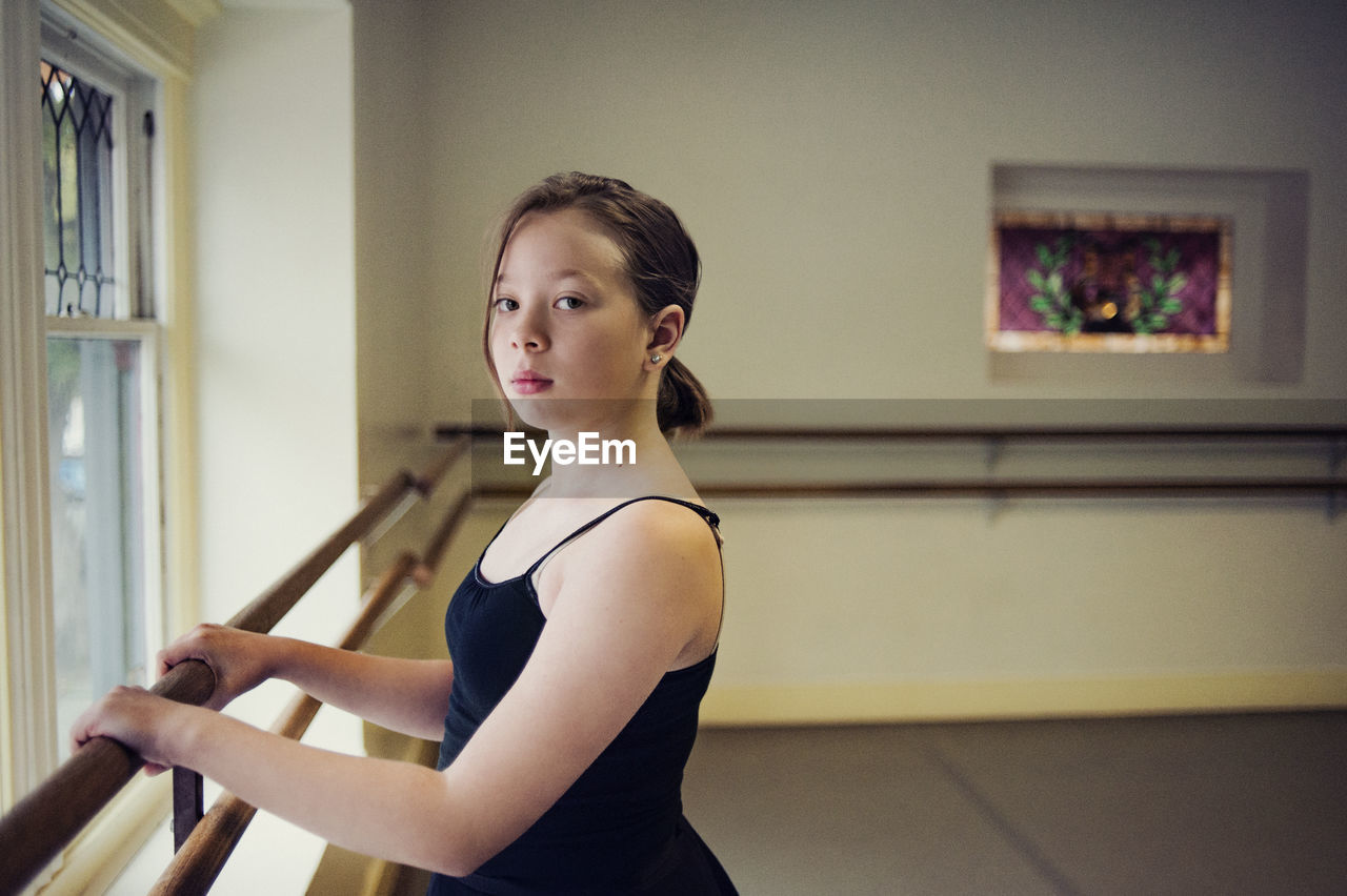 Portrait of ballet dancer standing at dance studio