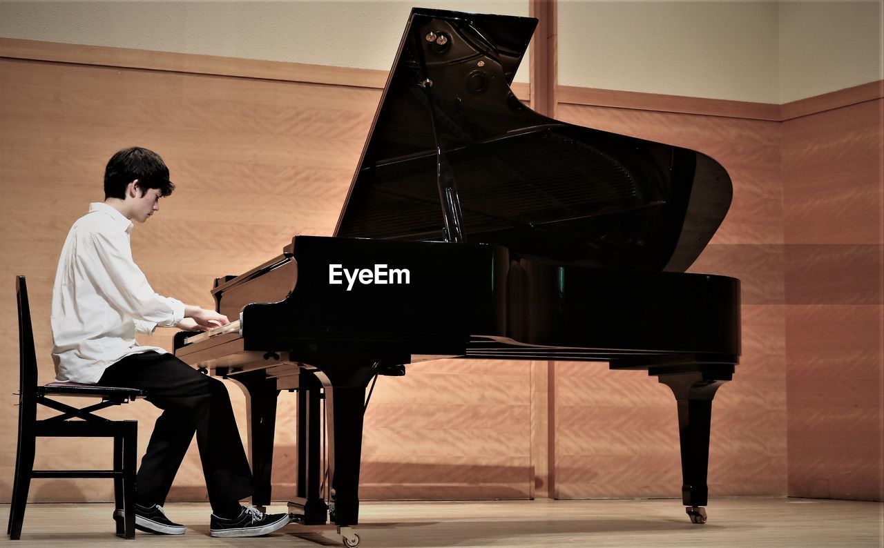 Teenage boy playing piano