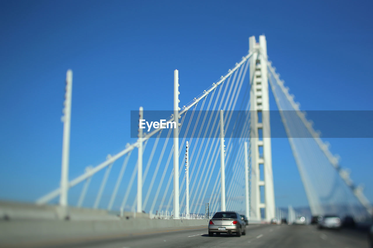 LOW ANGLE VIEW OF SUSPENSION BRIDGE AGAINST SKY