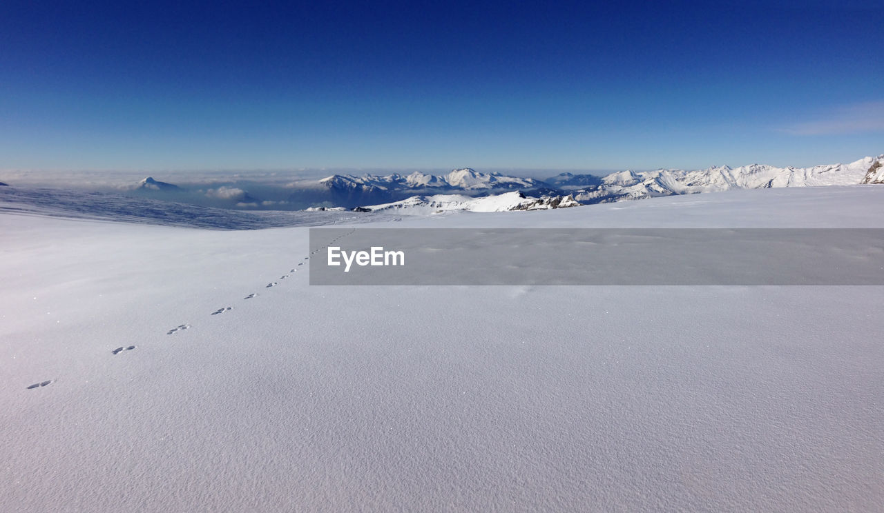 Scenic view of landscape against sky during winter