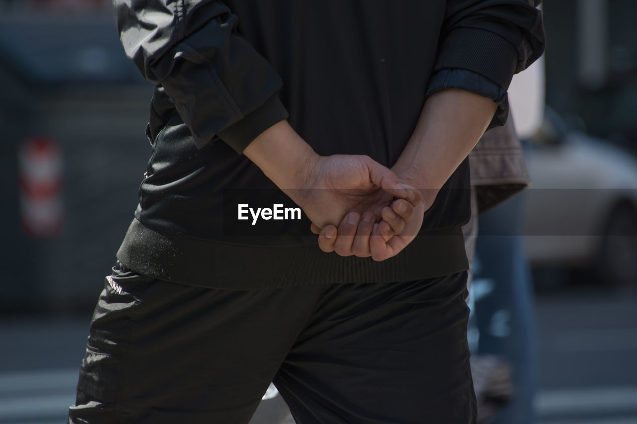 Close-up of man with hands clasped