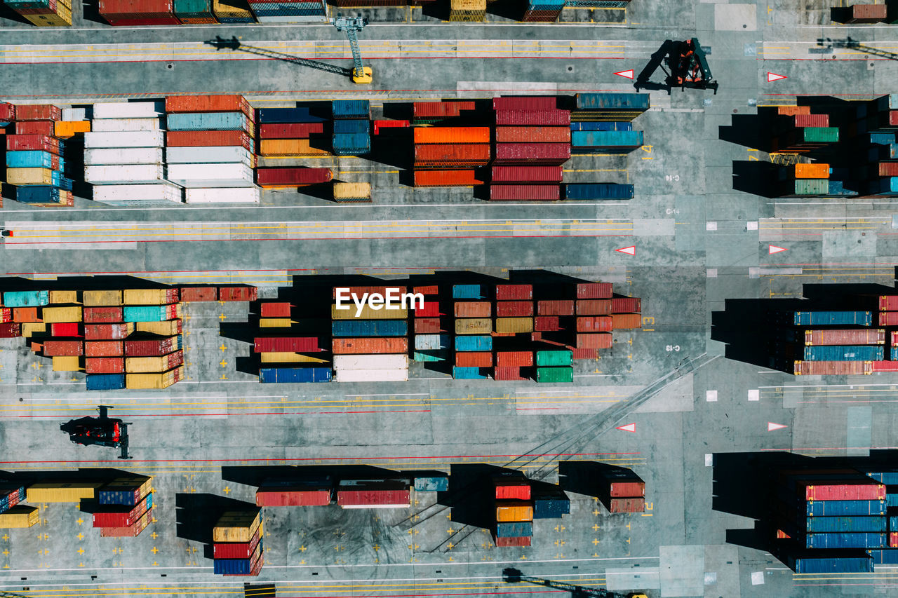 Aerial drone top down view of containers spread across a busy port