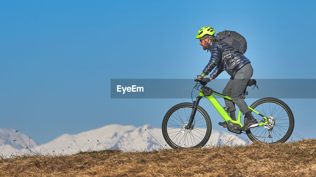 Young man with beard in mountain bike