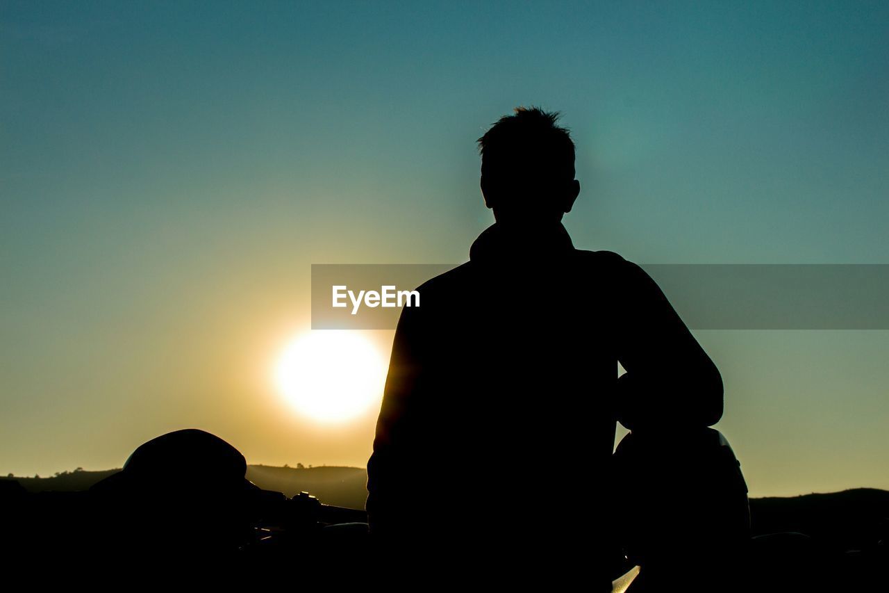 SILHOUETTE OF WOMAN AT SUNSET
