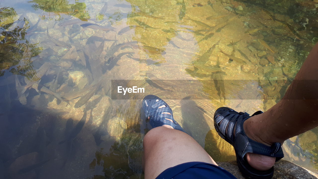 LOW SECTION OF MAN STANDING ON WATER