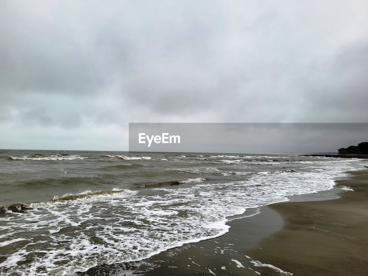 sea, water, land, beach, sky, wind wave, body of water, cloud, wave, motion, beauty in nature, ocean, scenics - nature, storm, shore, environment, nature, coast, surfing, sports, water sports, overcast, sand, horizon, storm cloud, dramatic sky, horizon over water, water's edge, coastline, landscape, wet, outdoors, rock, travel destinations, seascape, day, tranquility, travel, cloudscape, wind, tide, power in nature, tourism, atmospheric mood