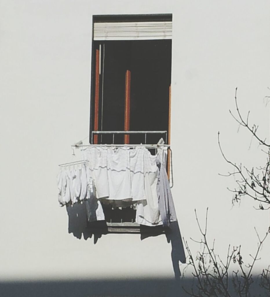 Clothes hanging on clothesline at balcony of building
