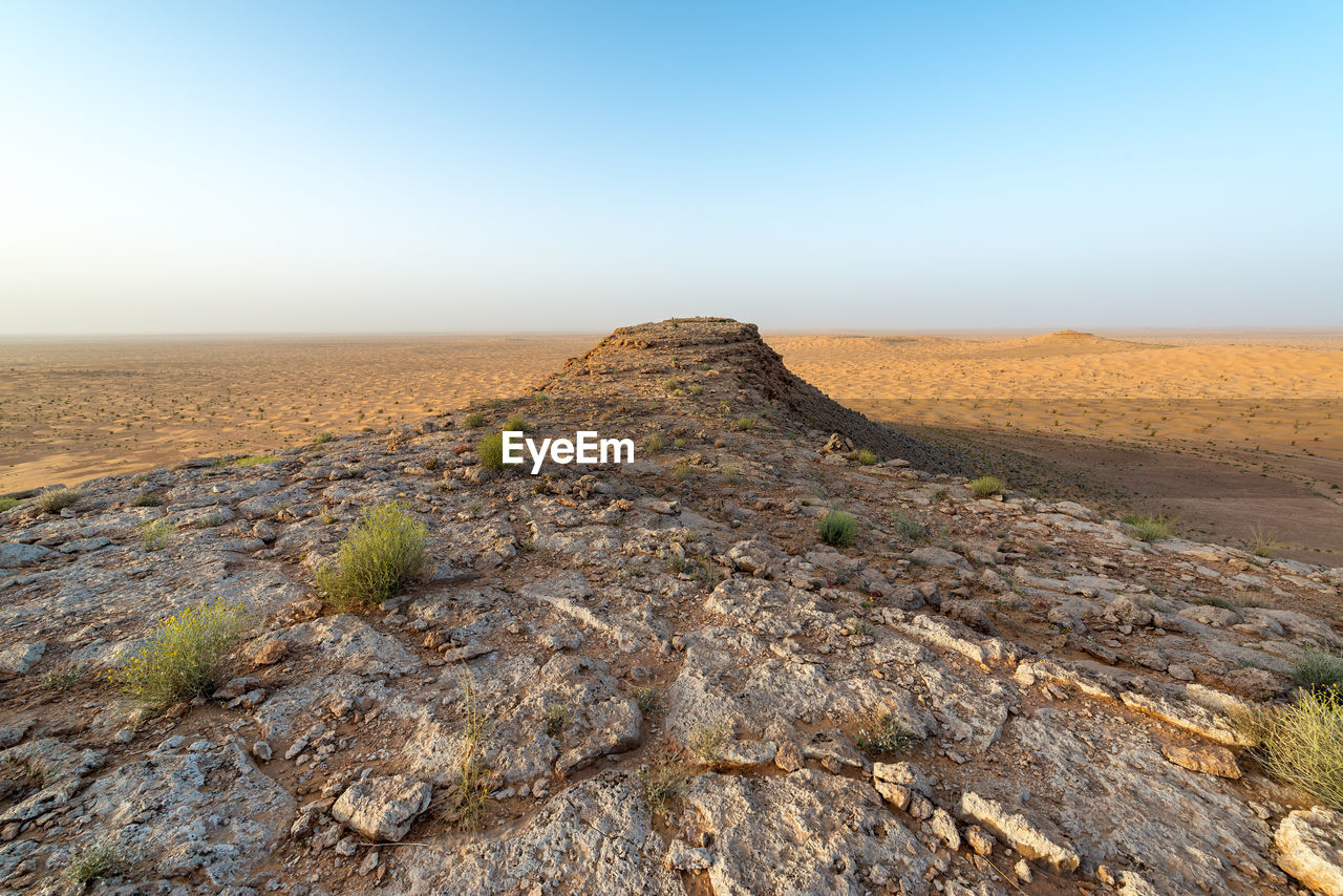 Scenic view of land against clear sky