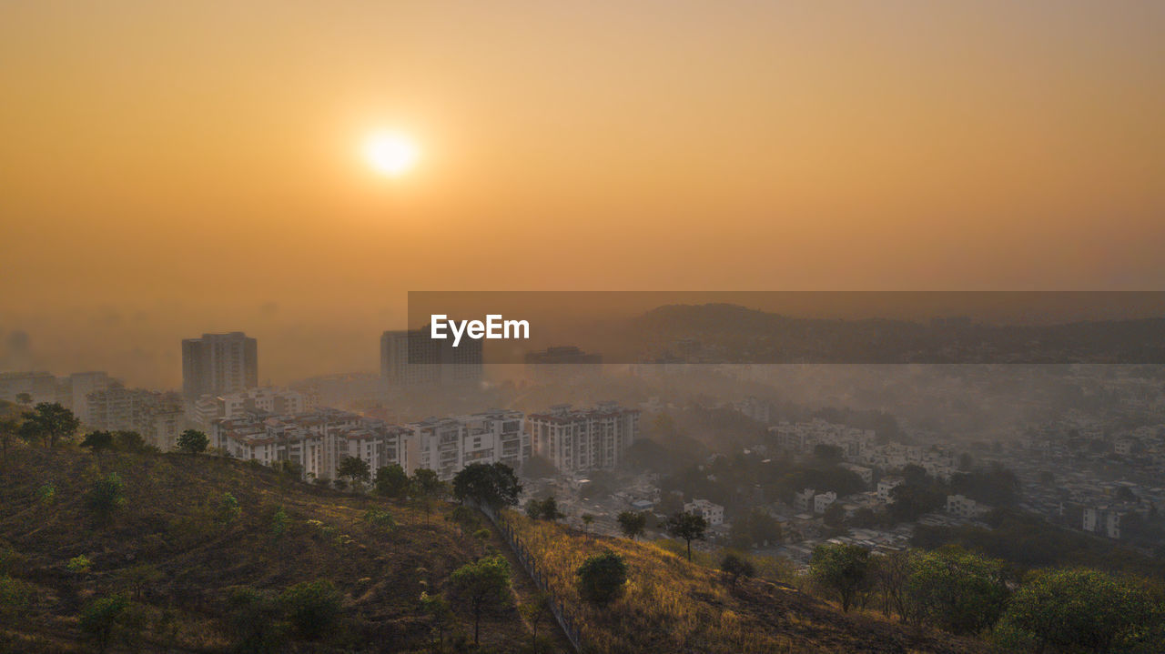 View of cityscape against sky during sunset