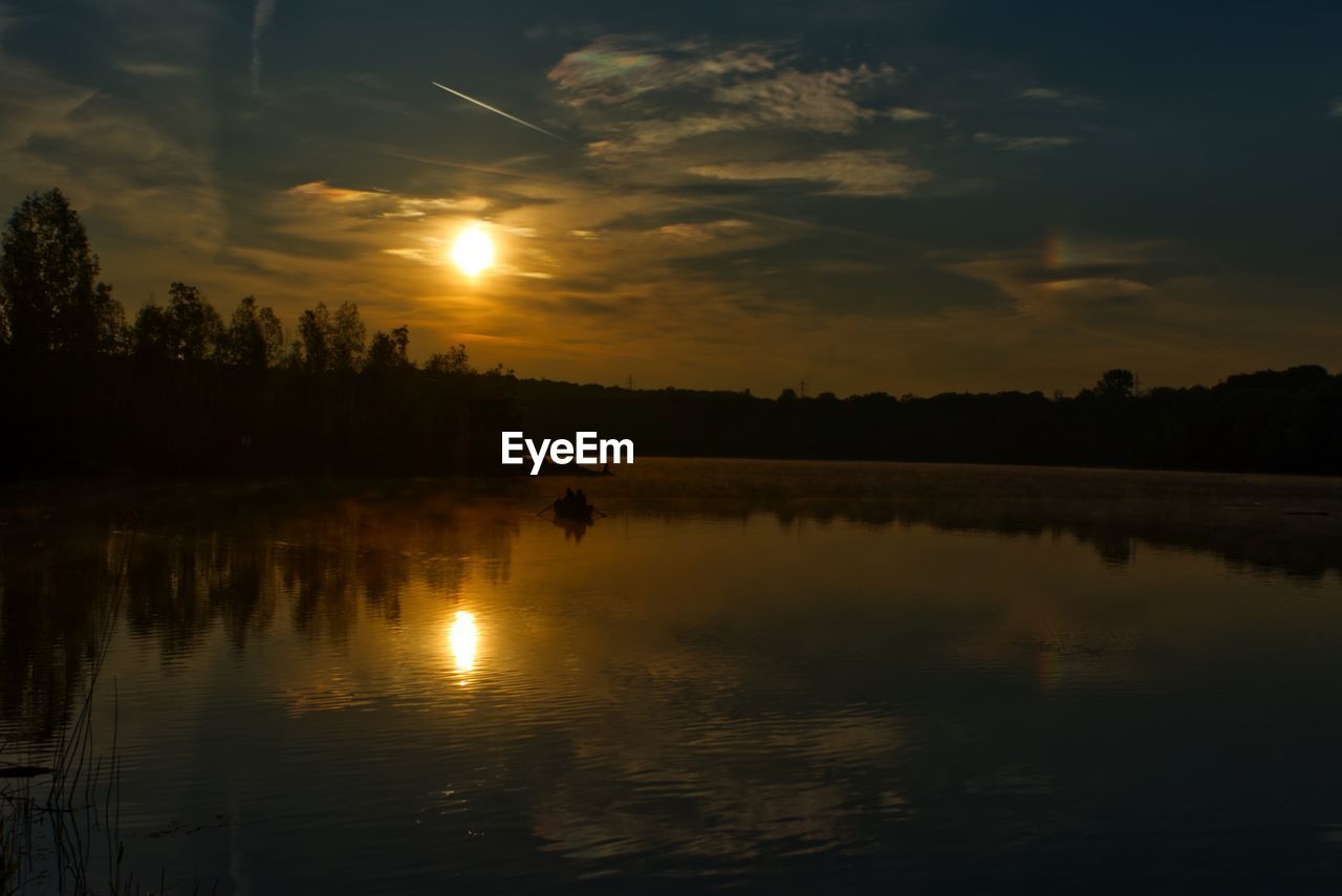 SILHOUETTE TREES BY LAKE AGAINST SKY DURING SUNSET