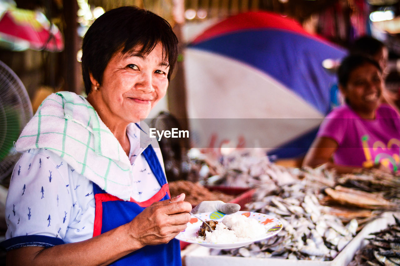 happiness, market, food, smiling, real people, looking at camera, cheerful, portrait, two people, outdoors, freshness, day, people, adult