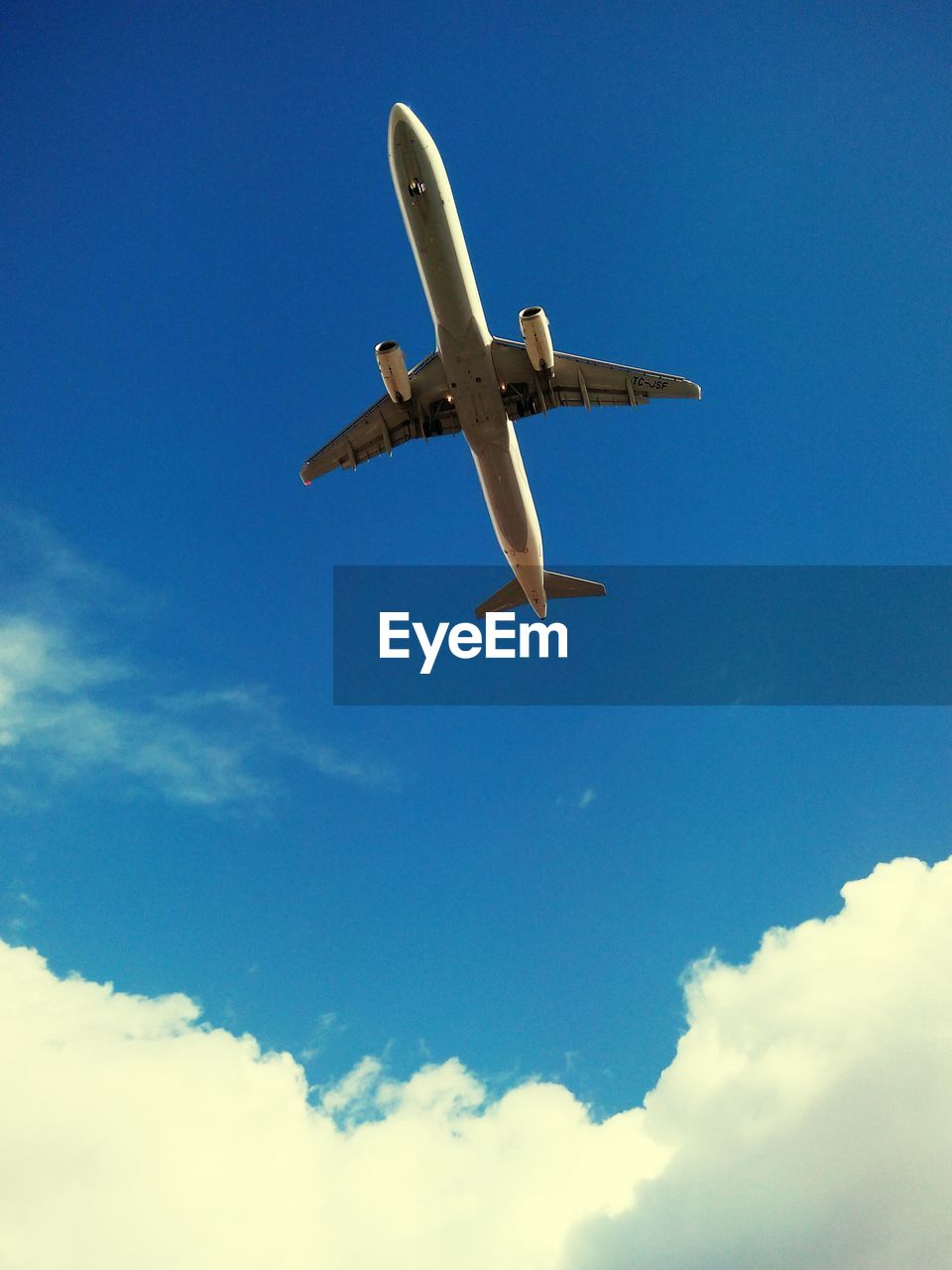 LOW ANGLE VIEW OF AIRPLANE FLYING IN SKY