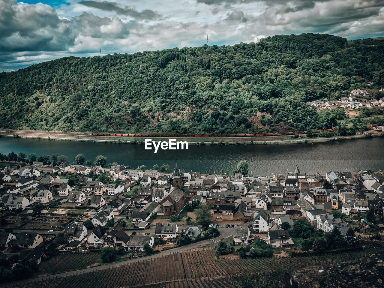 High angle view of river by buildings against sky