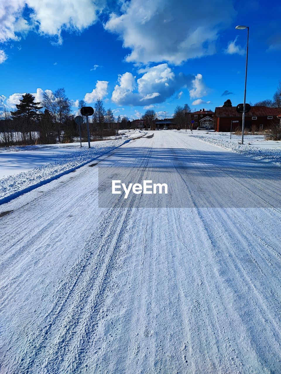 winter, snow, sky, cold temperature, environment, landscape, cloud, nature, scenics - nature, road, piste, transportation, beauty in nature, blue, land, no people, tree, frozen, plant, tranquility, rural scene, tranquil scene, travel, mountain, non-urban scene, white, outdoors, travel destinations, day, ice, horizon, pinaceae, coniferous tree, street, the way forward, freezing, social issues, diminishing perspective, remote, frost
